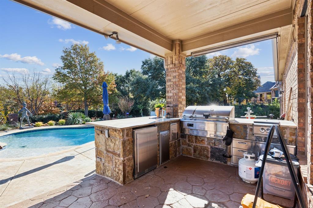 1608 Overlook Terrace Keller, TX 76262 - Photo 33 of 37 Deluxe outdoor kitchen, shielded from the elements with a view