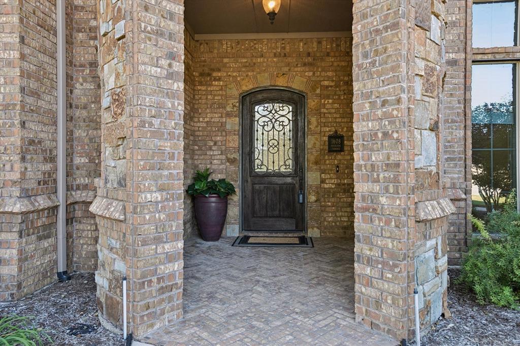 1608 Overlook Terrace Keller, TX 76262 - Photo 36 of 37 Covered entry cove, wrought iron, distressed wooden door.