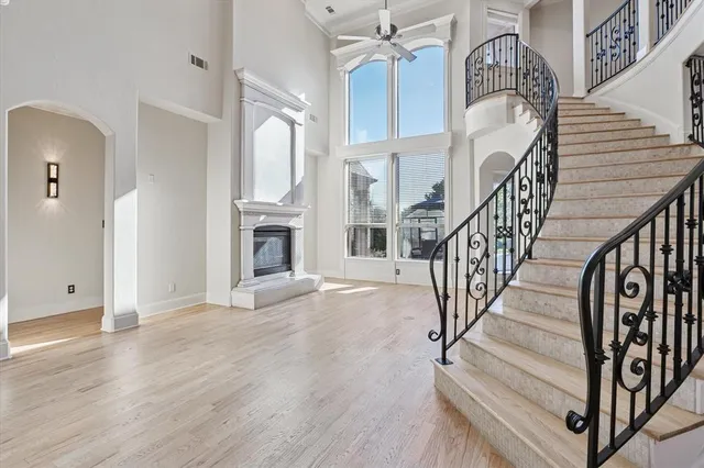 a view of a livingroom with wooden floor and stairs