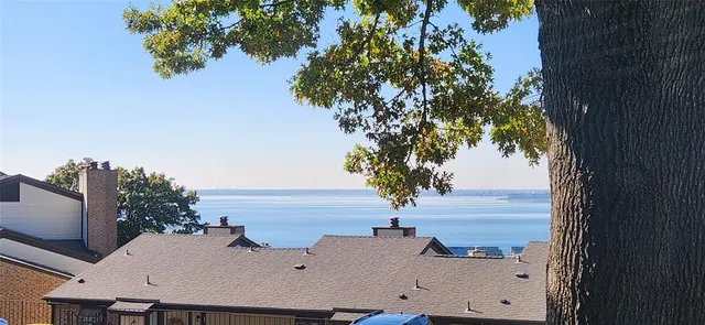 a kitchen with a sink a refrigerator and cabinets