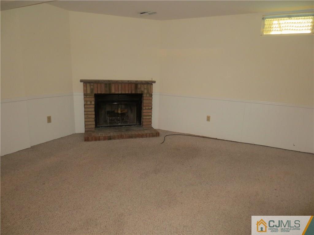 675 Bound Brook Road, Unit 23 Dunellen, NJ 08812 - Photo 13 of 26 a view of an empty room with a fireplace