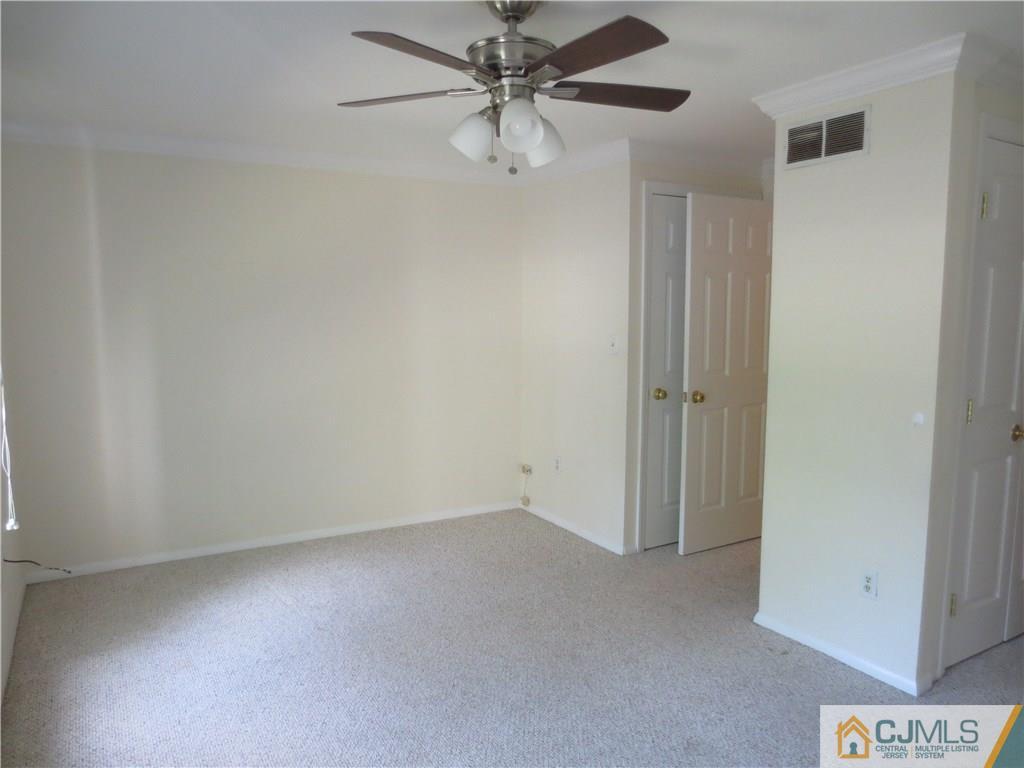 675 Bound Brook Road, Unit 23 Dunellen, NJ 08812 - Photo 15 of 26 an empty room with a ceiling fan and a window