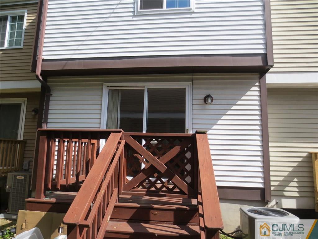 675 Bound Brook Road, Unit 23 Dunellen, NJ 08812 - Photo 3 of 26 a front view of a house with barbeque and wooden stairs