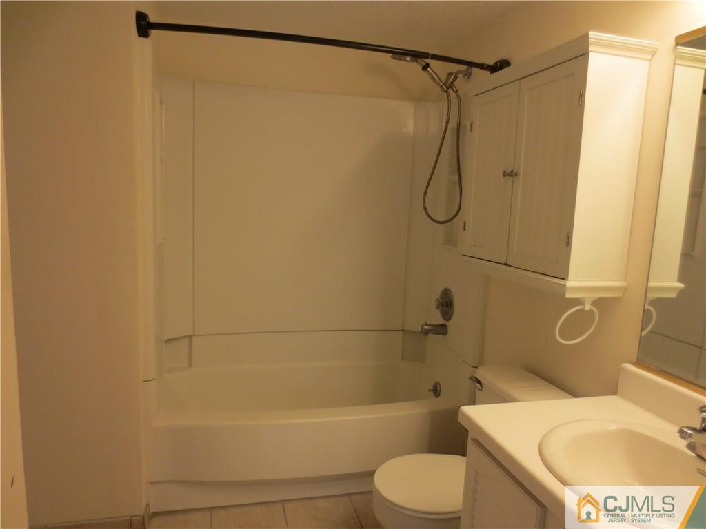 675 Bound Brook Road, Unit 23 Dunellen, NJ 08812 - Photo 24 of 26 a bathroom with a toilet and shower