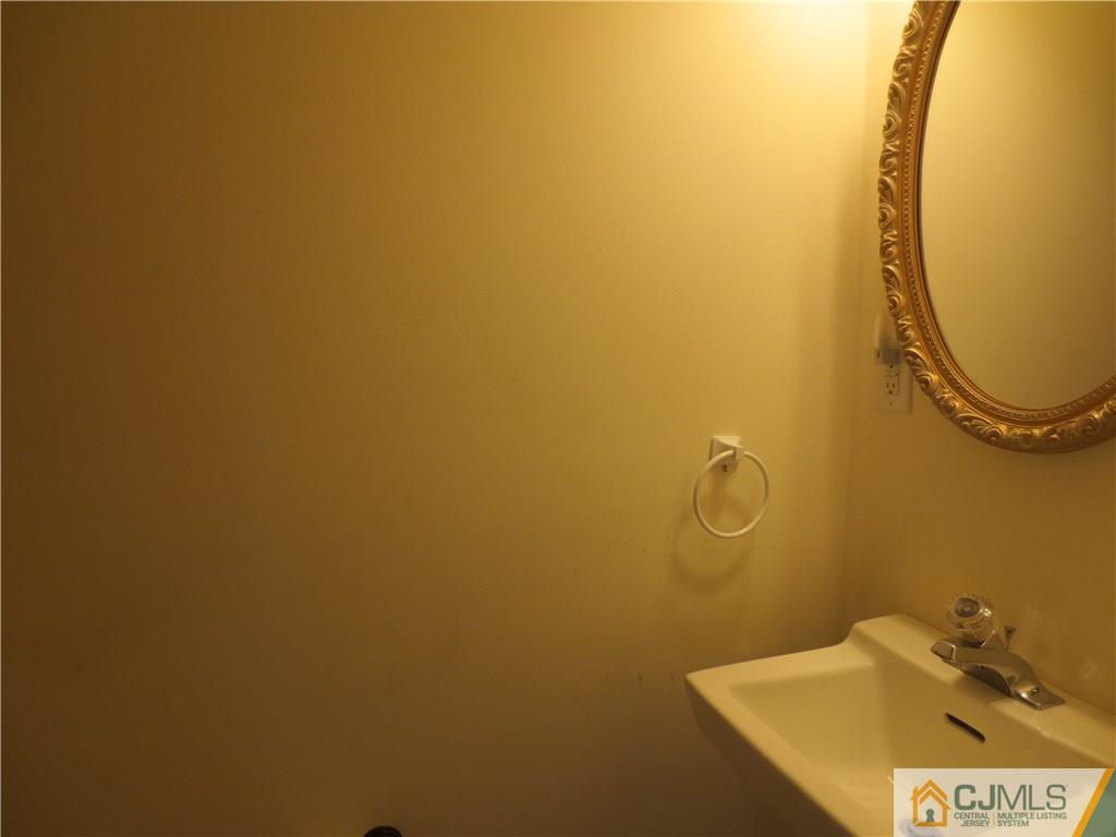 675 Bound Brook Road, Unit 23 Dunellen, NJ 08812 - Photo 26 of 26 a bathroom with a sink and mirror