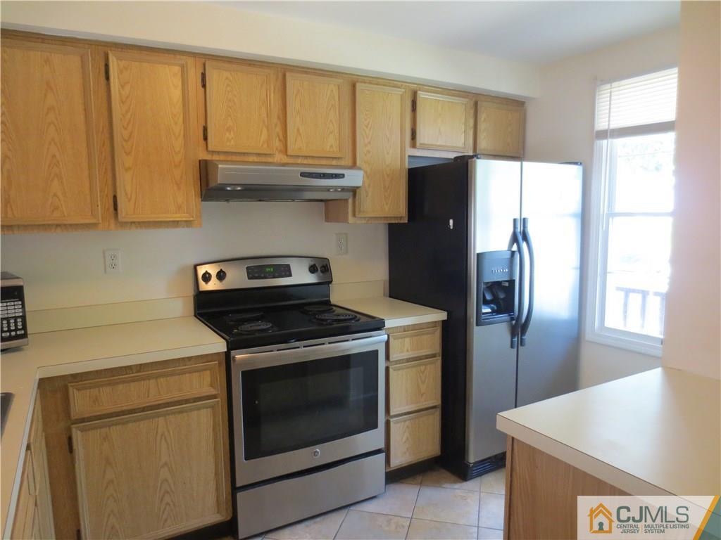 675 Bound Brook Road, Unit 23 Dunellen, NJ 08812 - Photo 5 of 26 a kitchen with stainless steel appliances granite countertop a stove a refrigerator and a sink