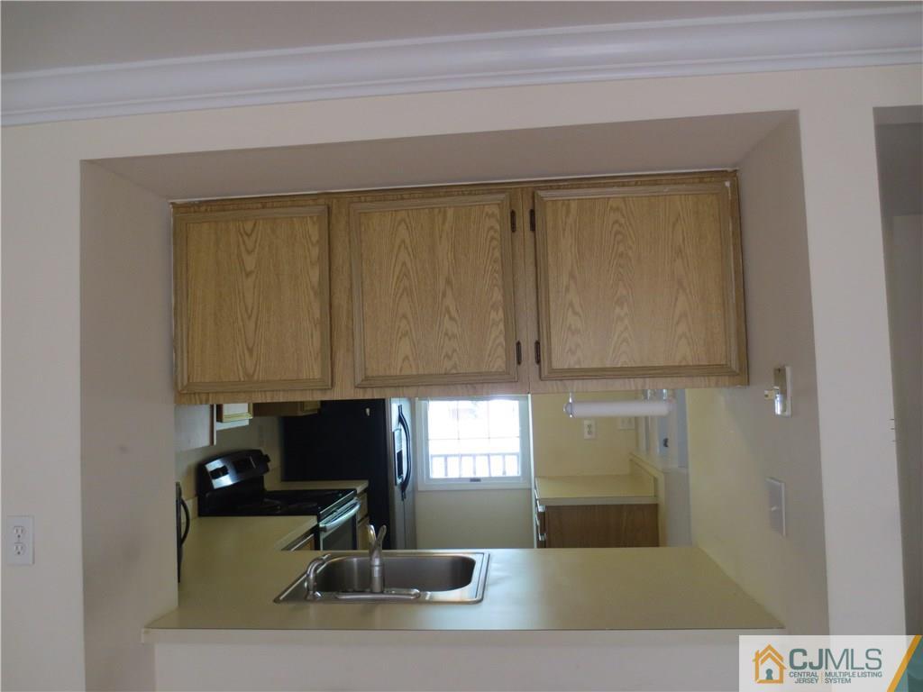 675 Bound Brook Road, Unit 23 Dunellen, NJ 08812 - Photo 8 of 26 a kitchen with a sink and a window