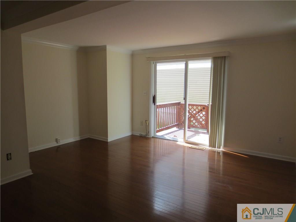 675 Bound Brook Road, Unit 23 Dunellen, NJ 08812 - Photo 10 of 26 an empty room with wooden floor and windows