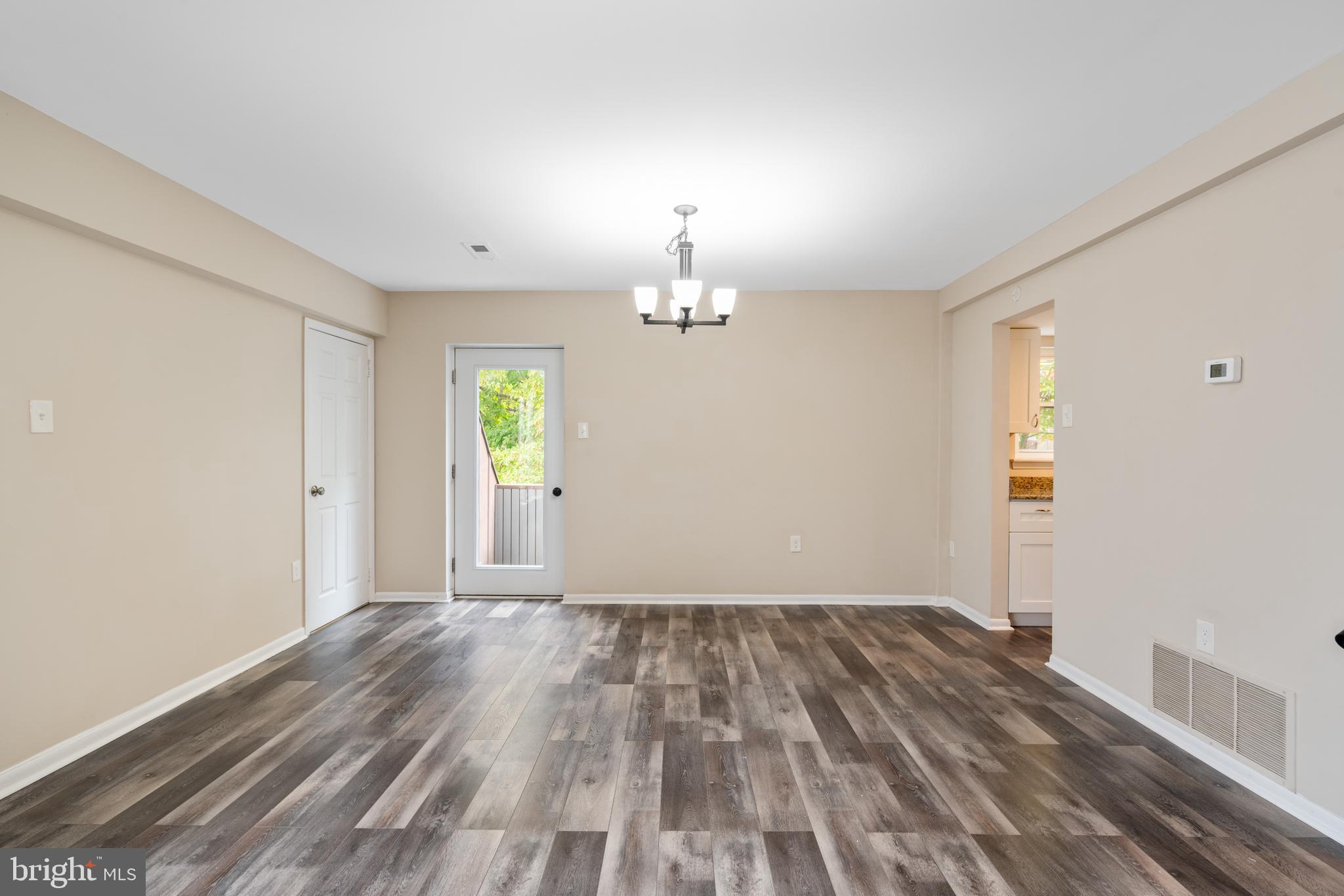 233 Township Line Road, Unit 5F Elkins Park, PA 19027 - Photo 14 of 25 wooden floor in an empty room with a window