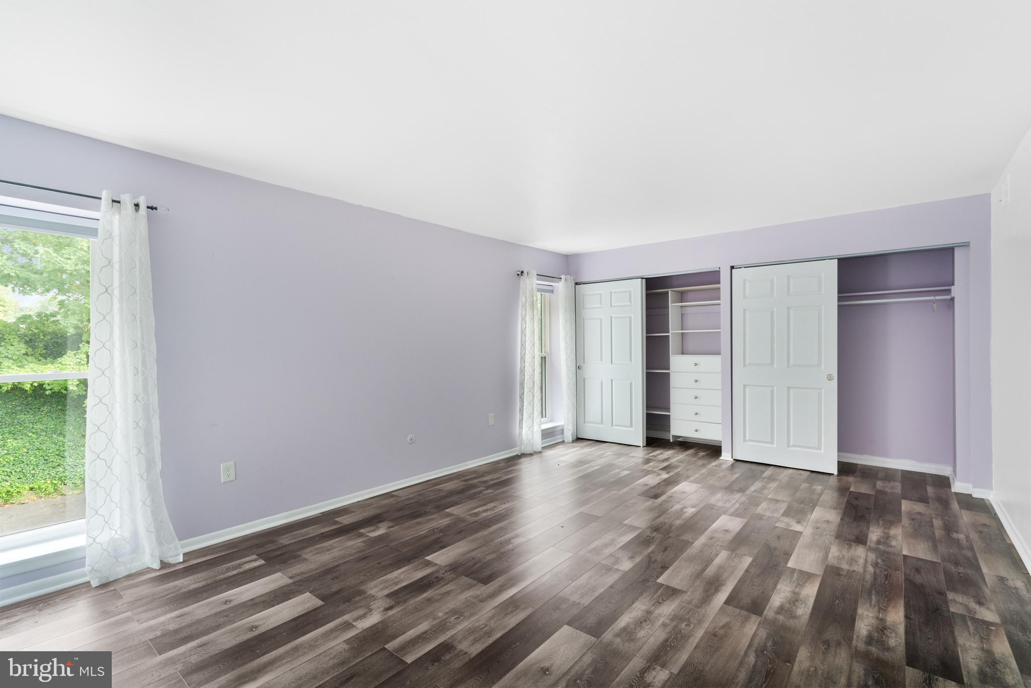 233 Township Line Road, Unit 5F Elkins Park, PA 19027 - Photo 21 of 25 a view of an empty room with wooden floor and a window