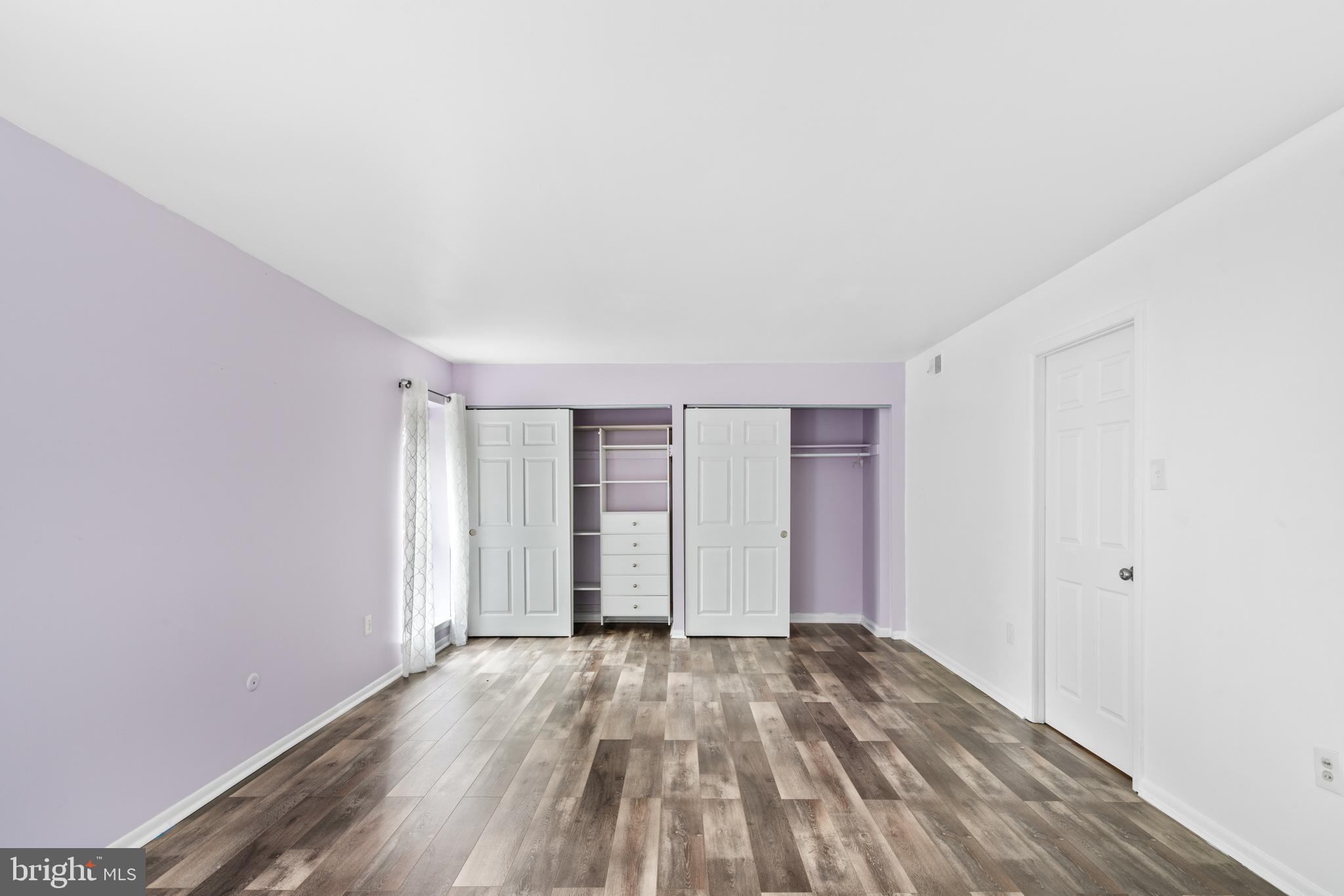 233 Township Line Road, Unit 5F Elkins Park, PA 19027 - Photo 8 of 25 an empty room with wooden floor and windows