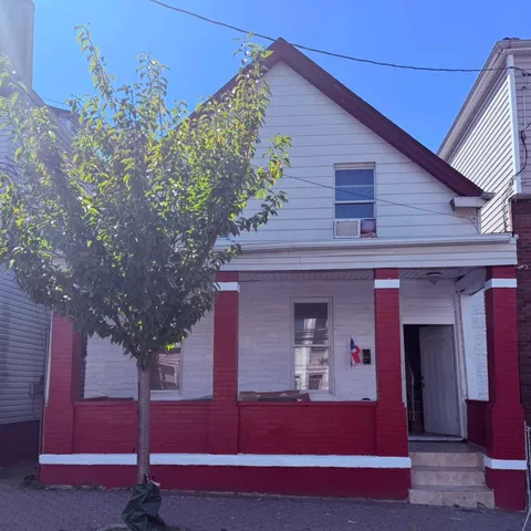 a view of a house with a tree