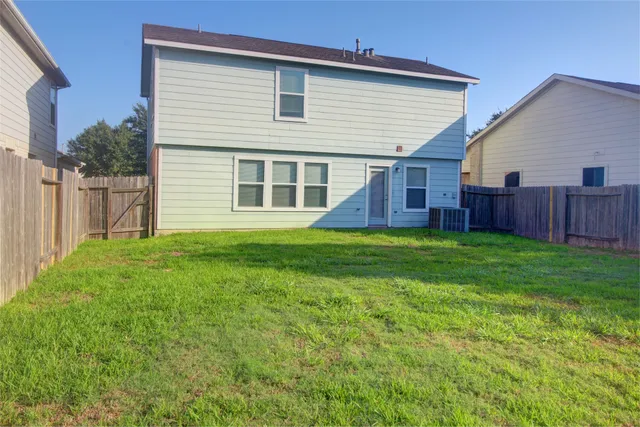 a view of a house with a yard and sitting area
