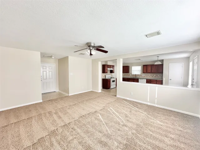 a view of a kitchen with refrigerator and windows