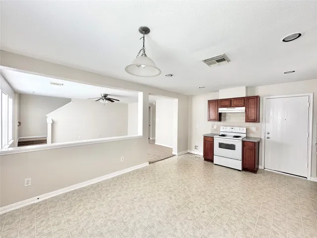 a kitchen with stainless steel appliances a refrigerator and a stove top oven