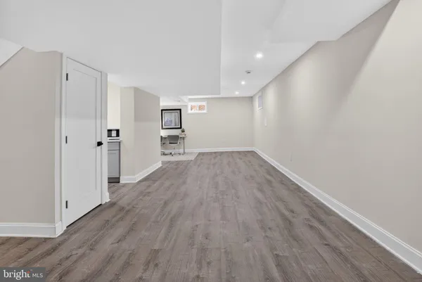 a view of a room with wooden floor