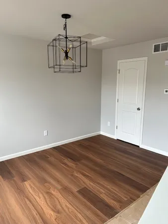 a view of a room with wooden floor