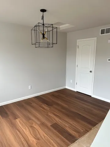 a view of a room with wooden floor