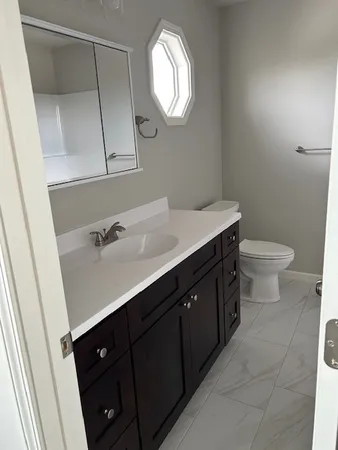 a bathroom with a sink vanity and a mirror