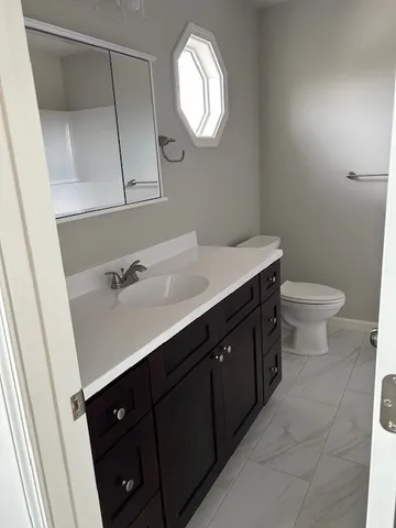 a bathroom with a sink vanity and a mirror