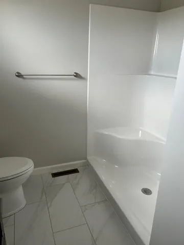 a bathroom with a granite countertop a toilet