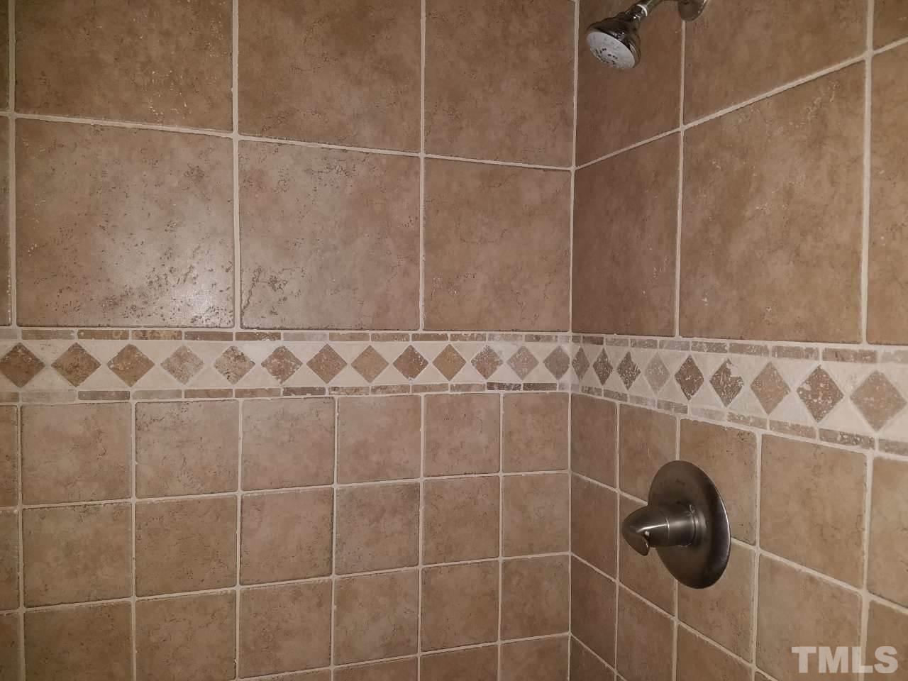 7712 Falcon Rest Circle, Unit 7712 Raleigh, NC 27615 - Photo 14 of 17 a bathroom with a shower