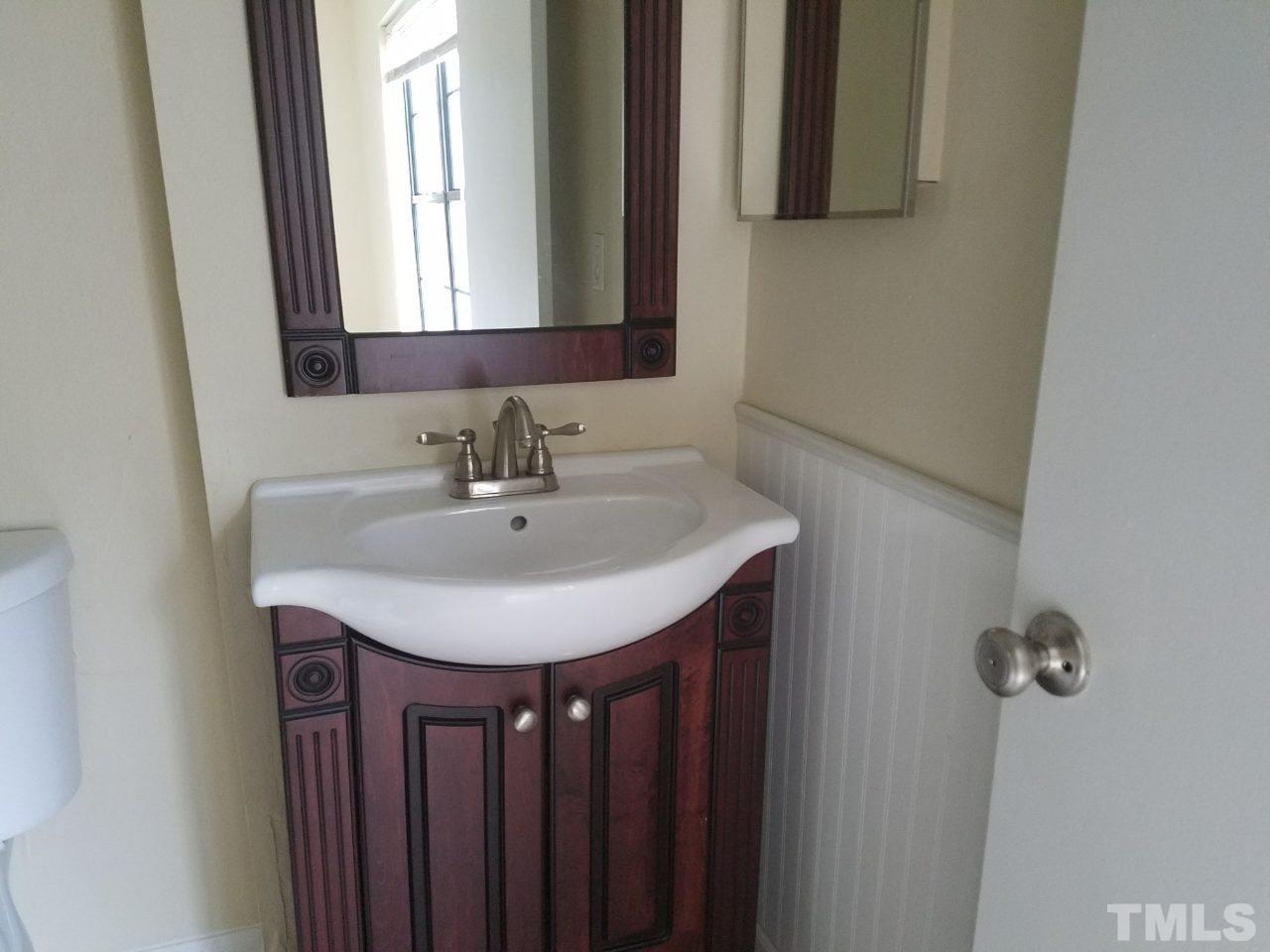 7712 Falcon Rest Circle, Unit 7712 Raleigh, NC 27615 - Photo 16 of 17 a bathroom with a sink and a mirror