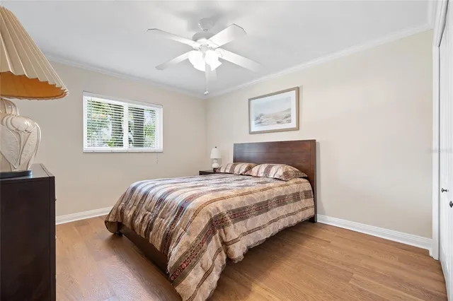 a bedroom with a bed lamp and a window