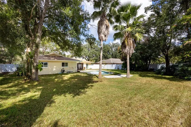 a view of a house with pool and sitting area