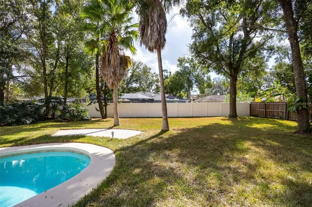 a view of a swimming pool with trees in the background