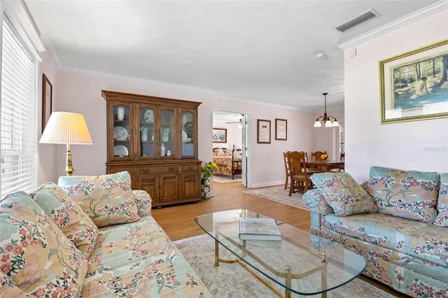 a bedroom with furniture and a wooden floor