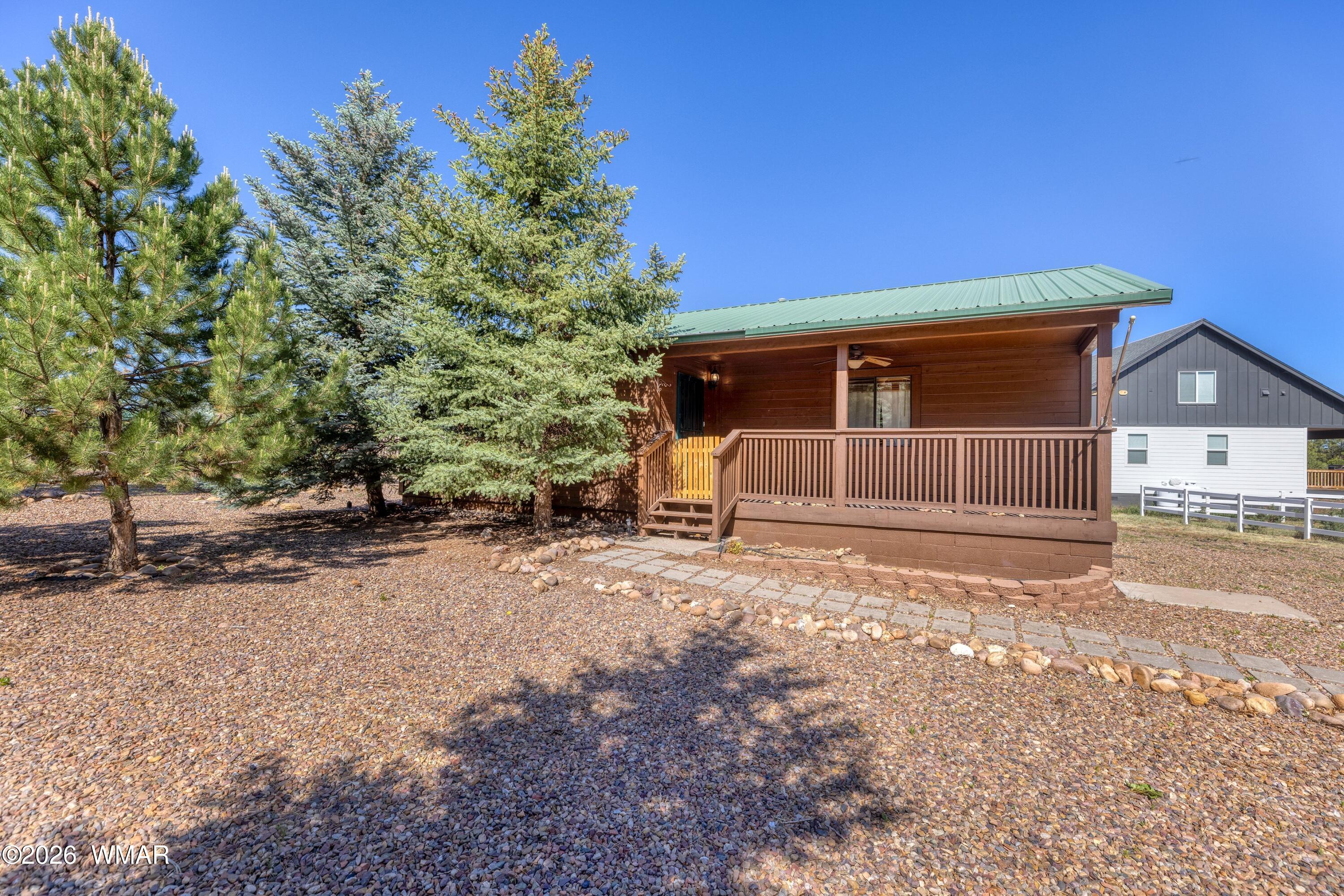 2722 Bain Trail Overgaard, AZ 85933 - Photo 21 of 28 a view of a house with a yard and garage