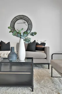 a living room with furniture and a mirror
