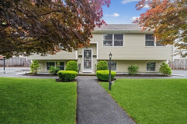 a front view of a house with a garden and porch