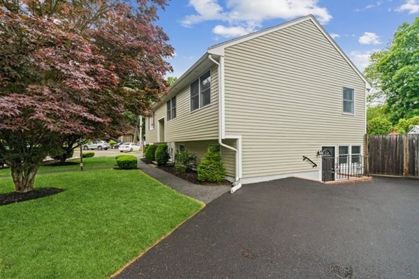 25 Osborne Street Lynn, MA 01905 - Photo 20 of 40 a view of a house with a yard and potted plants