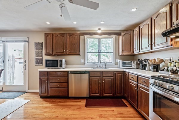 25 Osborne Street Lynn, MA 01905 - Photo 3 of 40 a kitchen with stainless steel appliances granite countertop a stove sink and cabinets