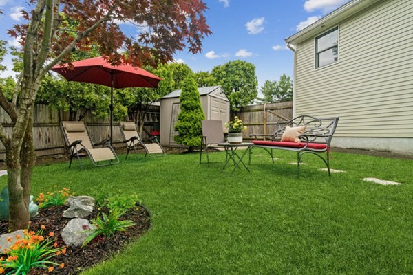 25 Osborne Street Lynn, MA 01905 - Photo 32 of 40 a chair and table sitting in backyard of the house