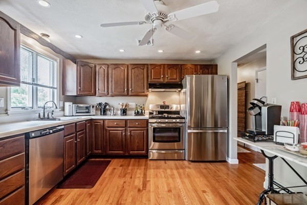 25 Osborne Street Lynn, MA 01905 - Photo 4 of 40 a kitchen with wooden floors appliances and cabinets