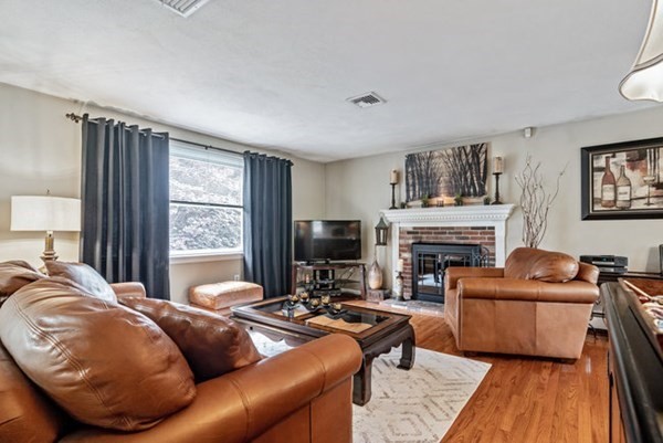25 Osborne Street Lynn, MA 01905 - Photo 7 of 40 a living room with furniture a fireplace and a flat screen tv
