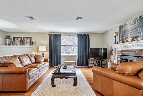 25 Osborne Street Lynn, MA 01905 - Photo 8 of 40 a living room with furniture fireplace and a flat screen tv