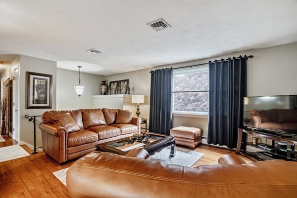 25 Osborne Street Lynn, MA 01905 - Photo 9 of 40 a living room with furniture a flat screen tv and a window