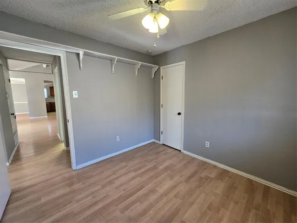 a view of an empty room and wooden floor