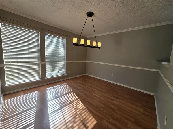 a view of a room with wooden floor and windows