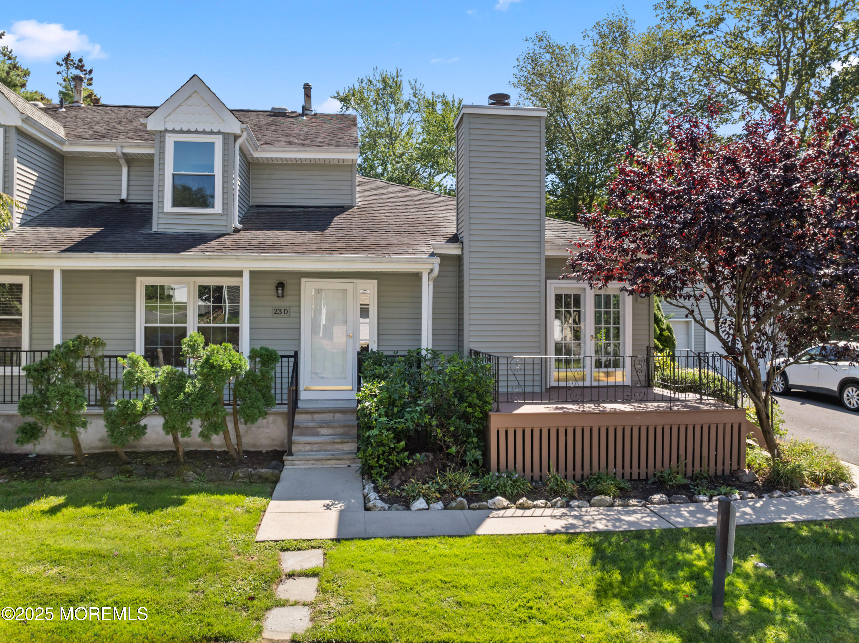 a front view of a house with garden and porch