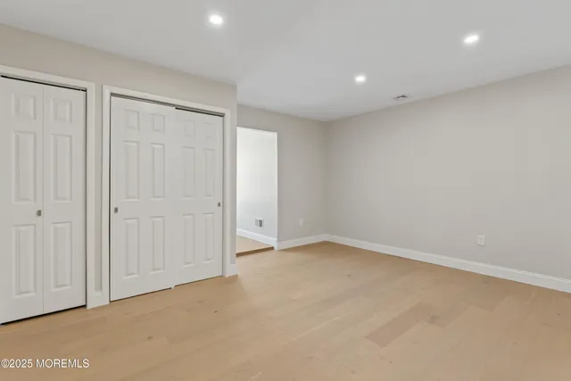 a view of hallway with wooden floor