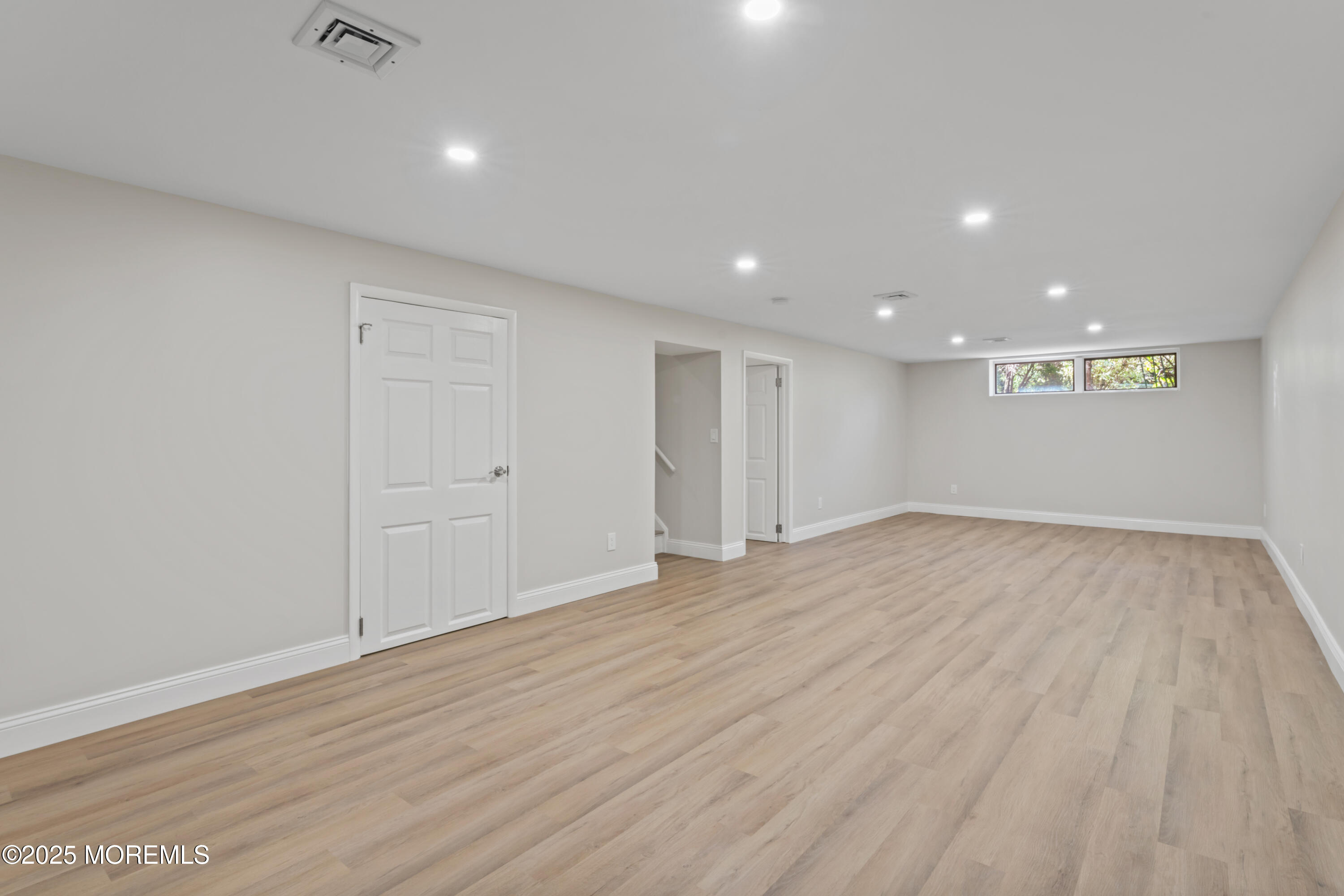 23 Mulberry Court, Unit D Brielle, NJ 08730 - Photo 25 of 40 a view of an empty room with wooden floor