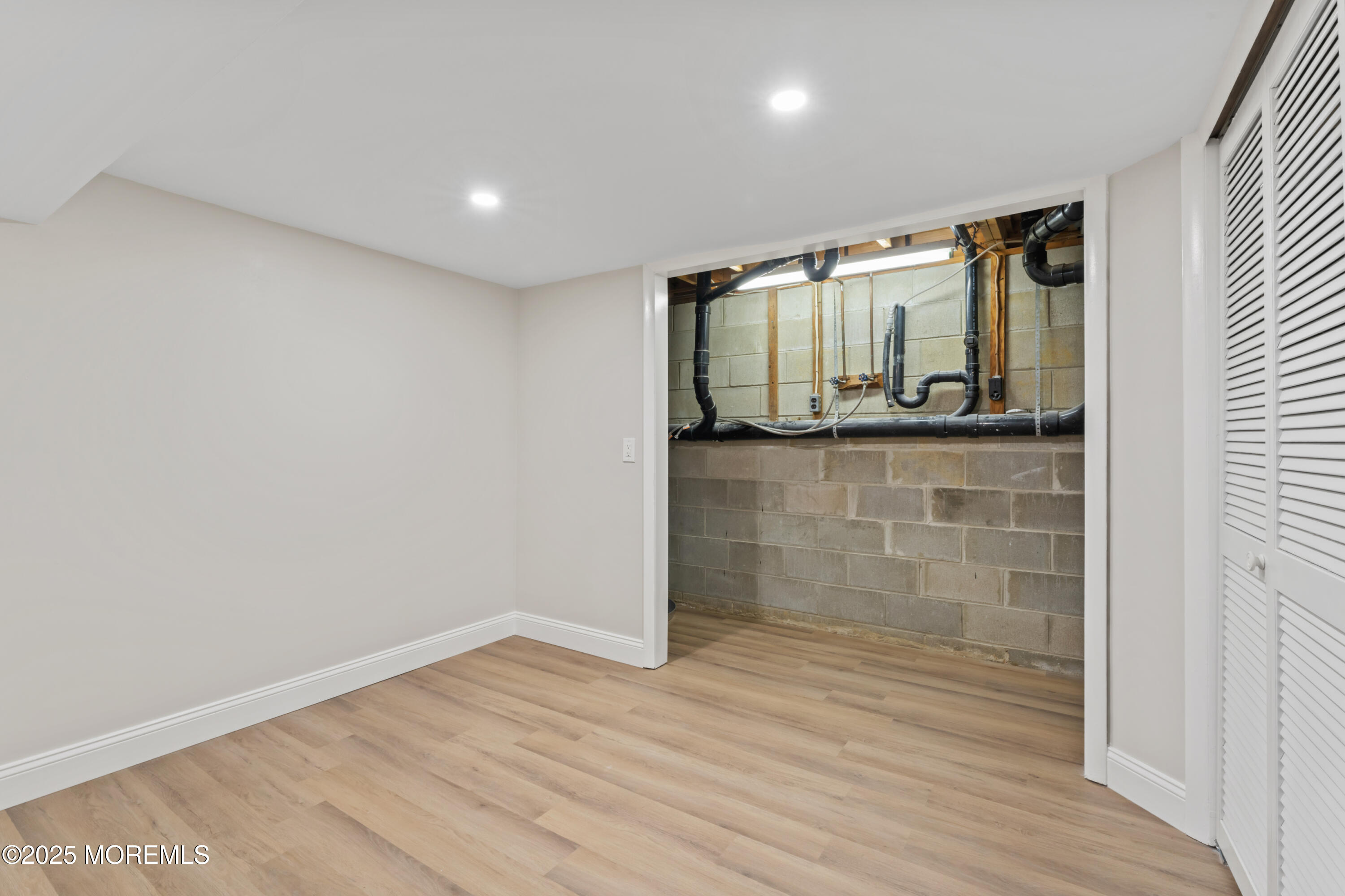 23 Mulberry Court, Unit D Brielle, NJ 08730 - Photo 28 of 40 a view of hallway with wooden floor