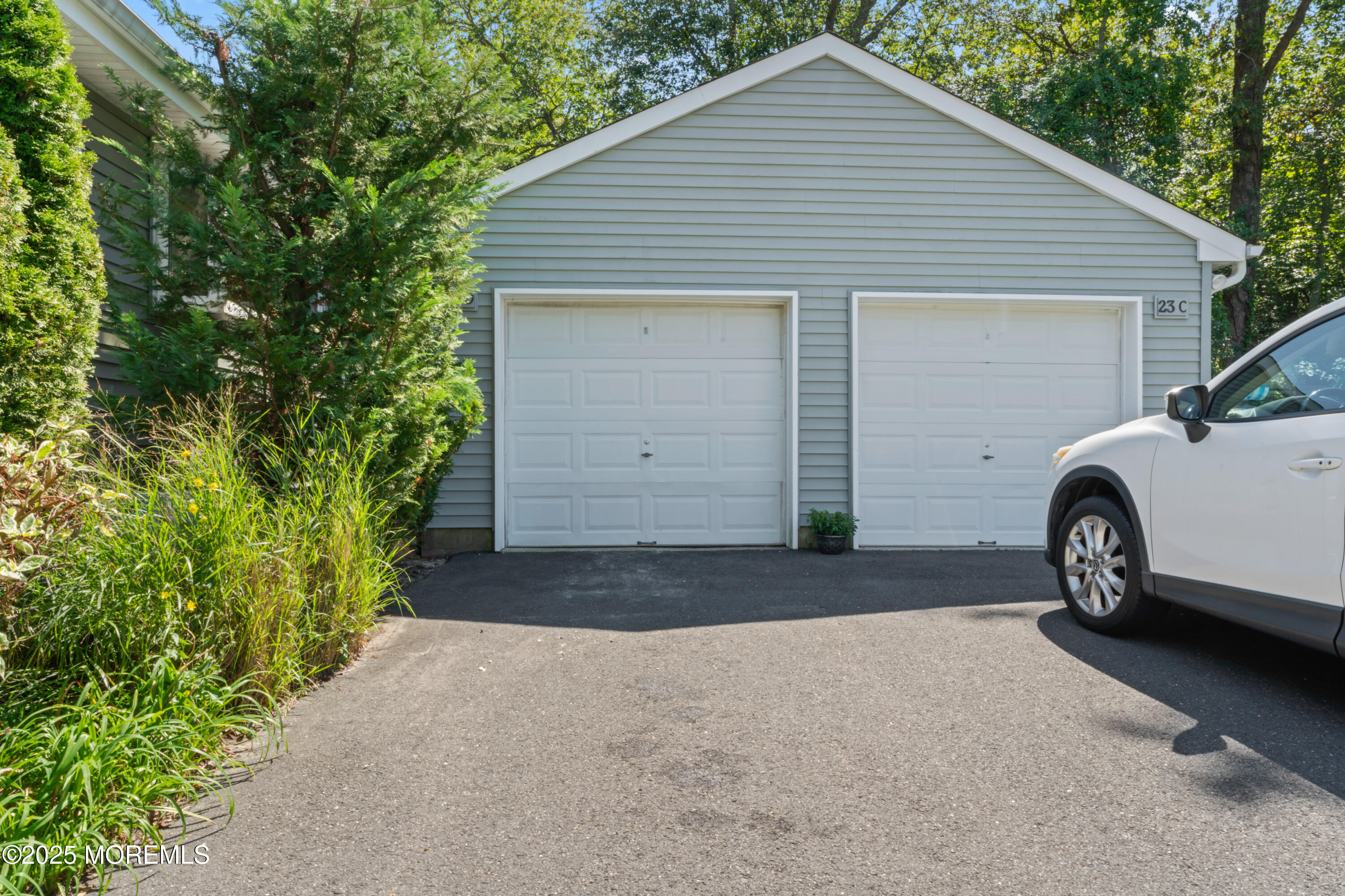 23 Mulberry Court, Unit D Brielle, NJ 08730 - Photo 31 of 40 a white house with a yard and parking space