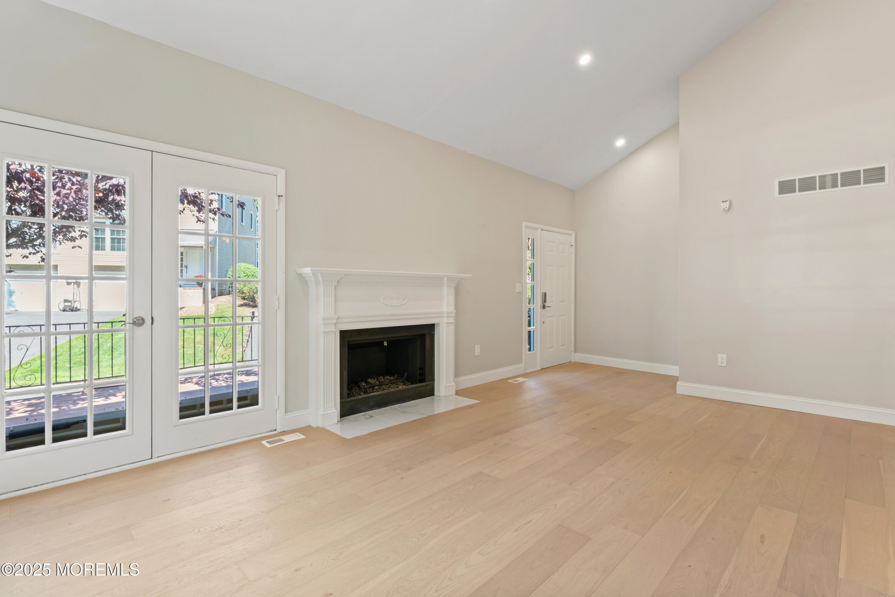 23 Mulberry Court, Unit D Brielle, NJ 08730 - Photo 5 of 40 wooden floor in an empty room with a fireplace