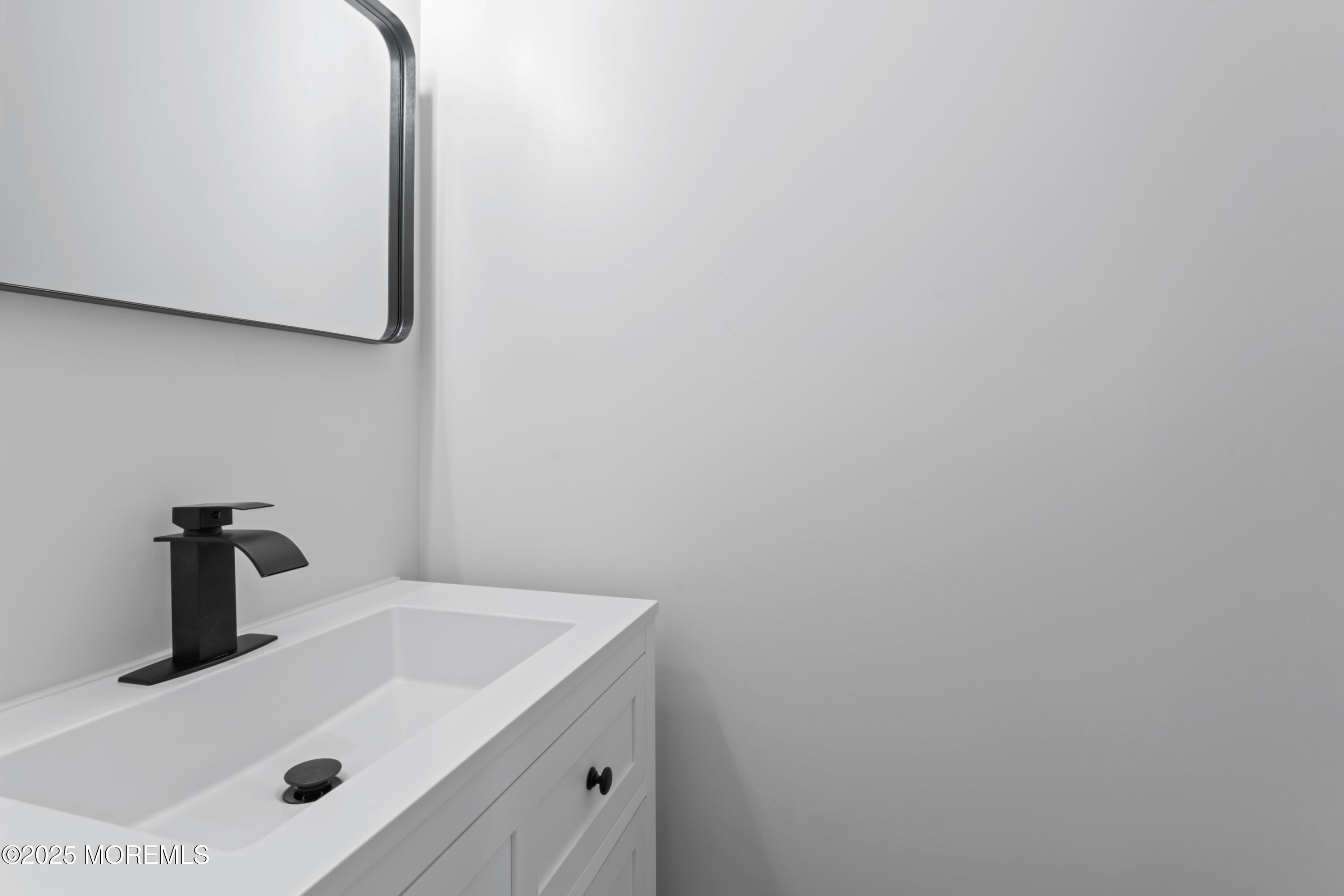 23 Mulberry Court, Unit D Brielle, NJ 08730 - Photo 9 of 40 a bathroom with a sink and a mirror